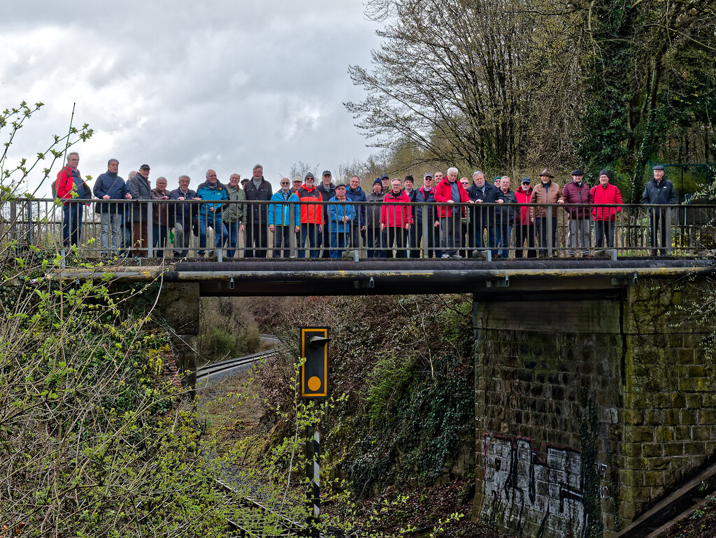 Die Wandergruppe auf einer Brücke, die über Gleise führt.